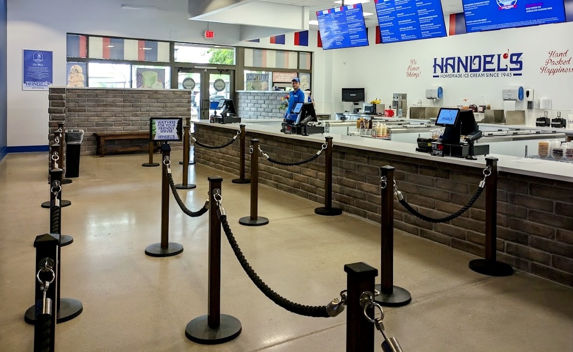 Decorative post and rope stanchions used in a busy customer service area.